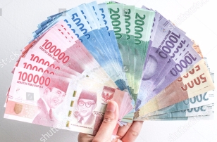 stock-photo-hand-holding-rupiah-indonesian-money-673462063
